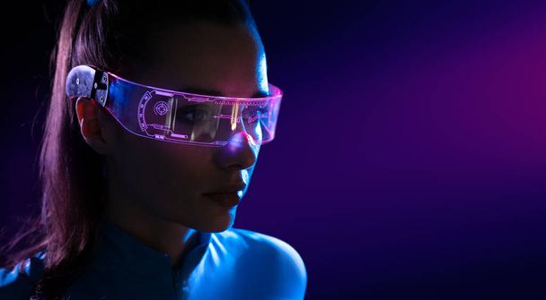 Konzept der Zukunftstechnologie oder des Unterhaltungssystems, Virtual Reality. Frauenporträt beleuchtet durch HUD-Schnittstelle - Foto, Bild