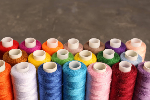 Set of color sewing threads on grey table - Фото, зображення