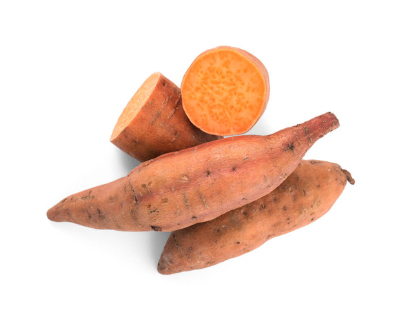 Whole and cut ripe sweet potatoes on white background, top view - Photo, image