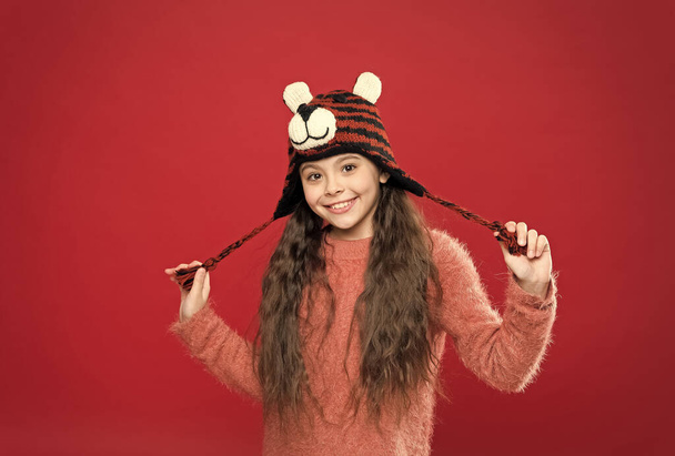 time for fun. kid in hat with ear flaps. child in knitted sweater. happy childhood. happy teen girl wear warm clothes. feel comfortable and cozy in any weather. winter holiday and vacation - Foto, imagen