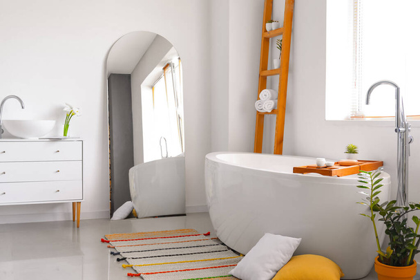 Интерьер светлой ванной комнаты с зеркалом - Фото, изображение
