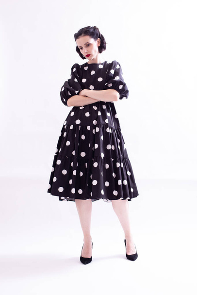 beautiful woman in a dress with polka dots with a red mouth - Foto, imagen