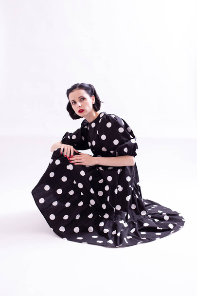 beautiful woman in a dress with polka dots with a red mouth - Foto, Imagem