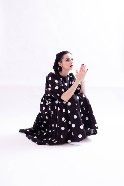 beautiful woman in a dress with polka dots with a red mouth - Valokuva, kuva
