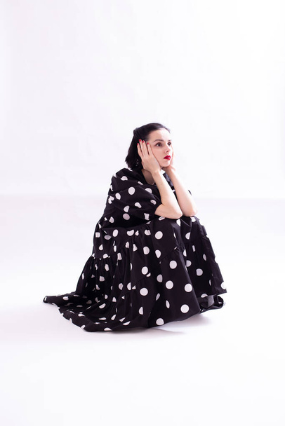 beautiful woman in a dress with polka dots with a red mouth - Fotó, kép
