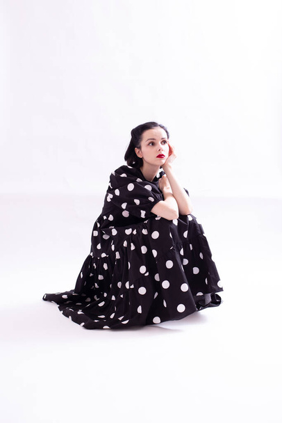 beautiful woman in a dress with polka dots with a red mouth - Photo, image