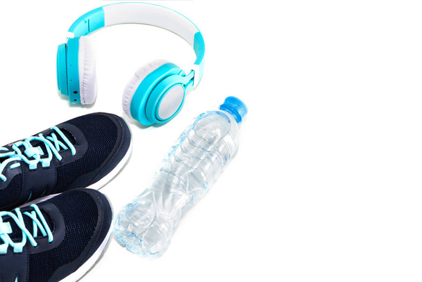 Sports equipment. Sneakers water and headphones, on a white background. - Zdjęcie, obraz