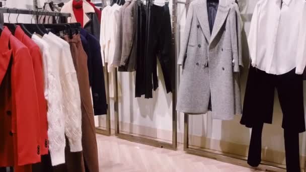 Clothing retail and sustainable fashion concept. Assortment of luxury menswear, autumn and winter collection in mass market brand store - Footage, Video