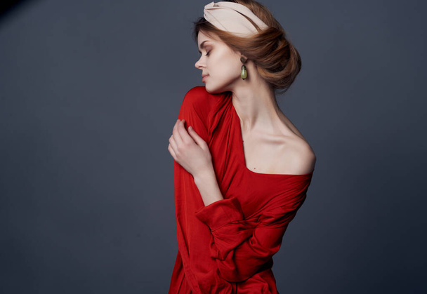 woman in red dress decoration posing luxury dark background - Photo, Image
