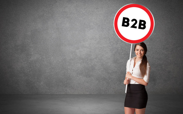 Young business person holdig traffic sign - Foto, Bild