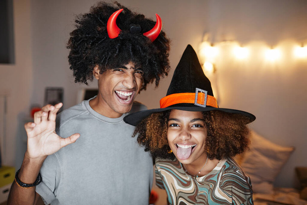 Jeune couple portant des costumes d'Halloween à la maison - Photo, image