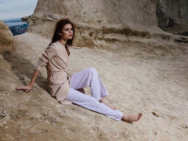 nő ül a homok elegáns stílusban - Fotó, kép