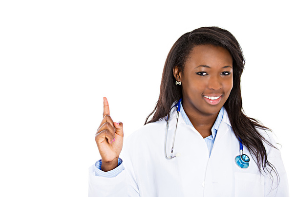 Female doctor pointing up with finger at copy space - Фото, изображение