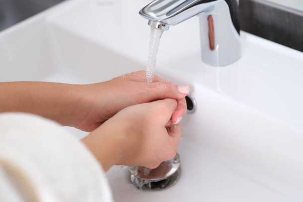 女は手をきれいな水で洗う - 写真・画像