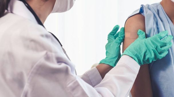 Young woman visits skillful doctor at hospital for vaccination - Fotó, kép