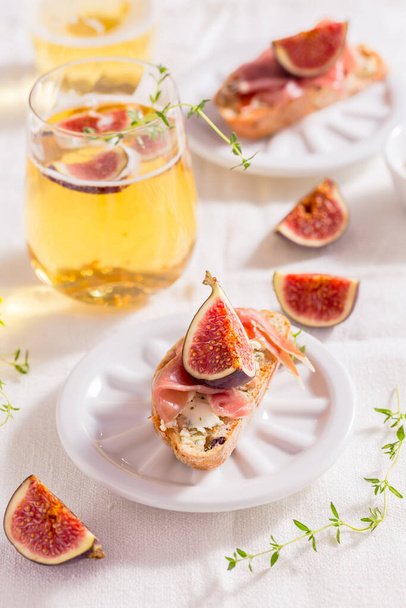 Malá svačinka, crostini se šunkou, fíkovým a jablečným vínem, italská antipasti - Fotografie, Obrázek