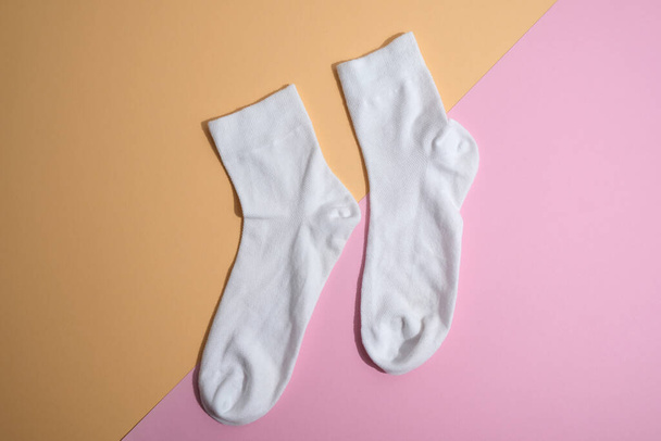 female  socks on pink  and yellow background - Foto, imagen