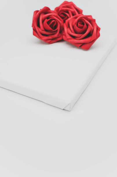 red rose flower head on a blank canvas on white with text space - Foto, immagini