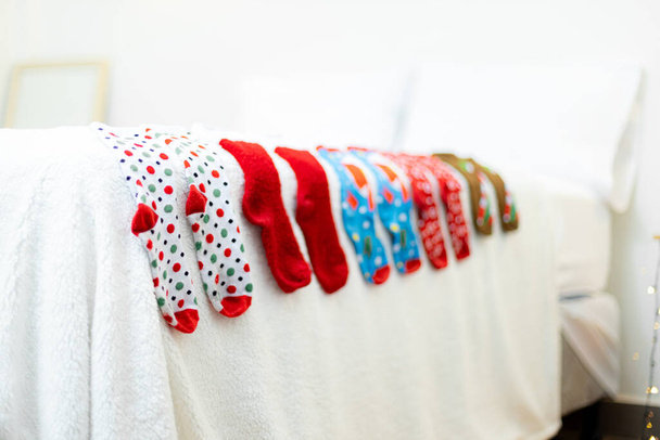 A closeup shot of Christmas design socks on the bed - Foto, Imagem