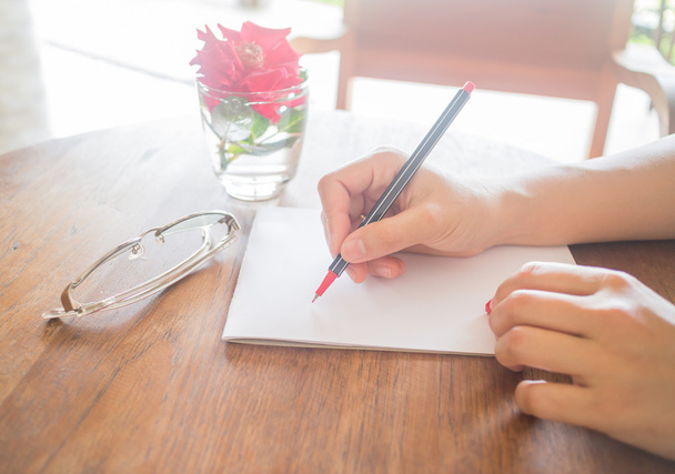 Escribir carta de amor en mesa romántica
 - Foto, imagen