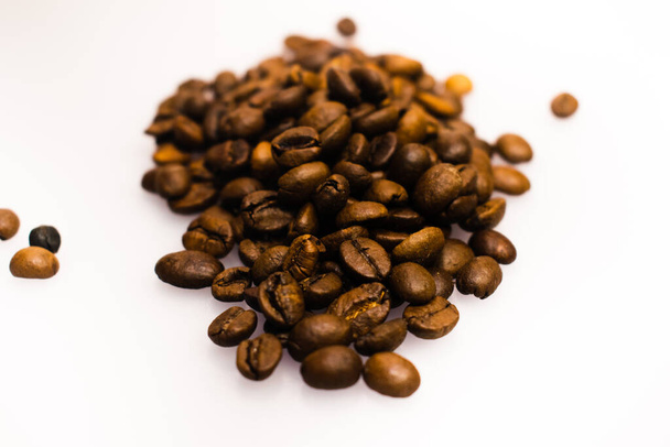 A closeup shot of coffee beans on a white backgrou - Фото, изображение