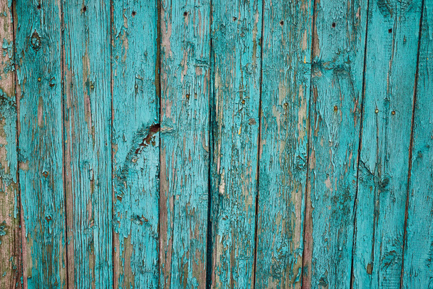 An old wooden wall with peeling paint. Beautiful textured background. Close-up - Fotó, kép