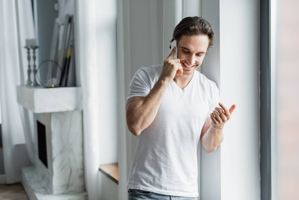 cheerful man talking on cellphone at home - Photo, Image