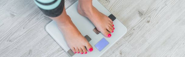 cropped view of barefoot woman estimating weight on floor scales, banner - Photo, Image