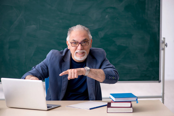 Old male teacher in tele-education concept - Photo, Image