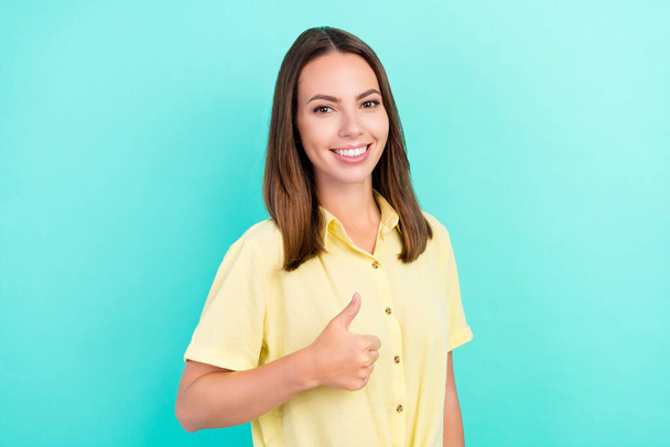 Photo of happy young joyful woman show hand thumb up smile enjoy good mood isolated on teal color background - Fotó, kép