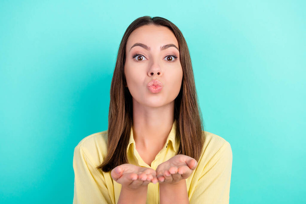 Photo of lovely millennial brunette lady blow kiss wear yellow blouse isolated on teal color background - Φωτογραφία, εικόνα
