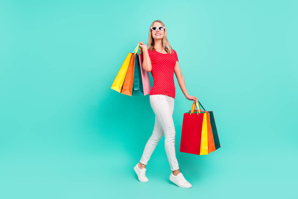Full length body size photo woman going on shopping wearing stylish sunglass isolated bright teal color background - Фото, изображение