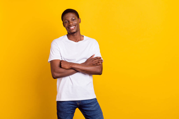 Portrait of attractive cheerful guy folded arms copy space isolated over bright yellow color background - Foto, afbeelding