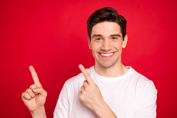 Photo portrait brunet guy in white shirt laughing pointing fingers empty space isolated vivid red color background - Fotografie, Obrázek