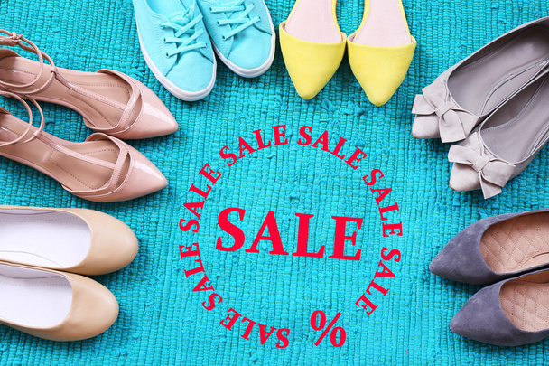 Concept of discount. Female fashion shoes on blue carpet - Foto, Bild