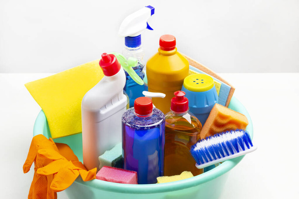 Set of household chemicals for cleaning the apartment in green plastic bowl. White background. - Φωτογραφία, εικόνα