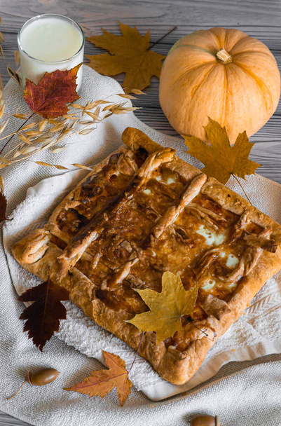 Autumn still life pumpkin pie on white textile milk in a glass, vertical photography. - Photo, Image