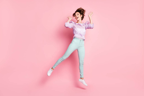 Full size photo of young happy excited smiling positive dreamy girl jumping look copyspace isolated on pink color background - Фото, изображение