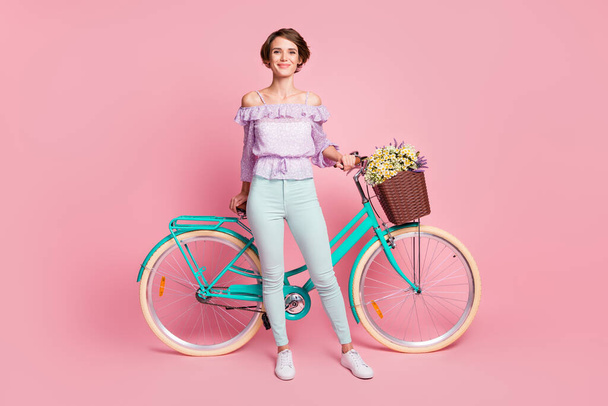 Full size photo of young attractive lovely pretty cheerful smiling positive girl with bicycle isolated on pink color background - Fotografie, Obrázek