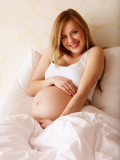 Pregnant Woman Sitting On Bed - Foto, Imagen