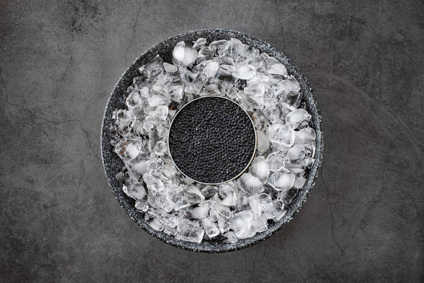 Black caviar in can on ice - Valokuva, kuva