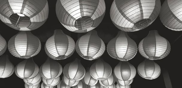 Beautiful Chinese lantern decorating and hanging on ceiling at China temple, Singapore in black and white tone. Object for decoration on festival or celebration. - Fotó, kép