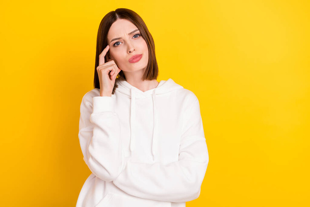 Portrait of attractive doubtful girl making decision overthinking isolated over bright yellow color background - Фото, изображение