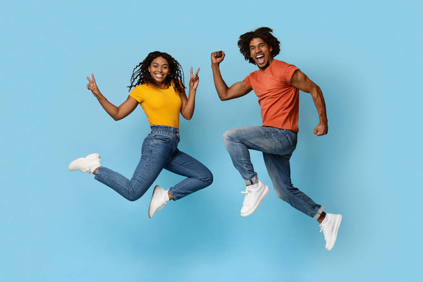 Carefree african american couple fooling on blue - Fotó, kép