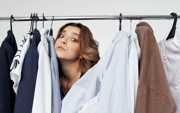emotional woman clothes hanger dresser fashion interior light background - Photo, Image