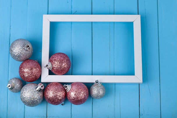 Frame and Christmas decor on a blue background. Christmas card. Place for your text. - Фото, зображення