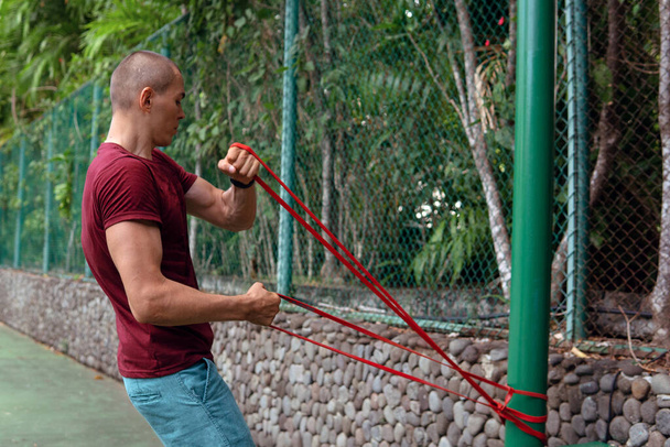 a man doing with rubber bands - Φωτογραφία, εικόνα