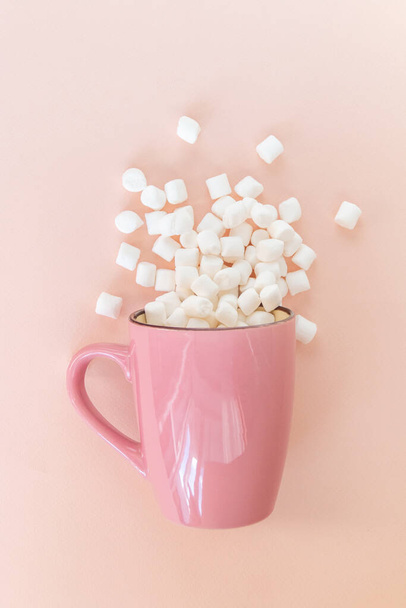 white marshmallow  on a pink background with space for text - Photo, image