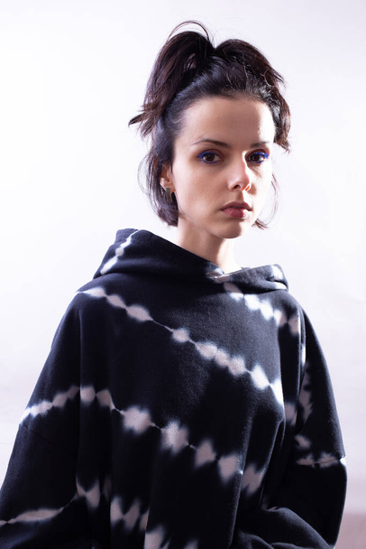 girl in a black hoodie on a white background - Fotografie, Obrázek