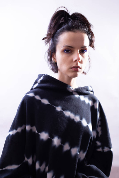 girl in a black hoodie on a white background - Fotografie, Obrázek
